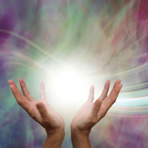 two hands open with a ball of light in the middle representing manifestors in human design